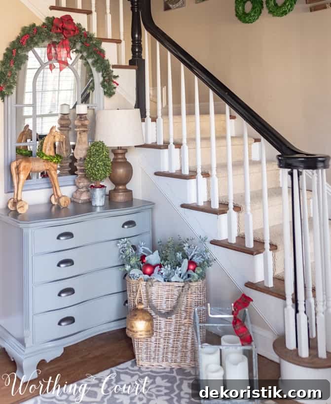 A dresser beside the stairs with a mirror on it and a basket beside it.