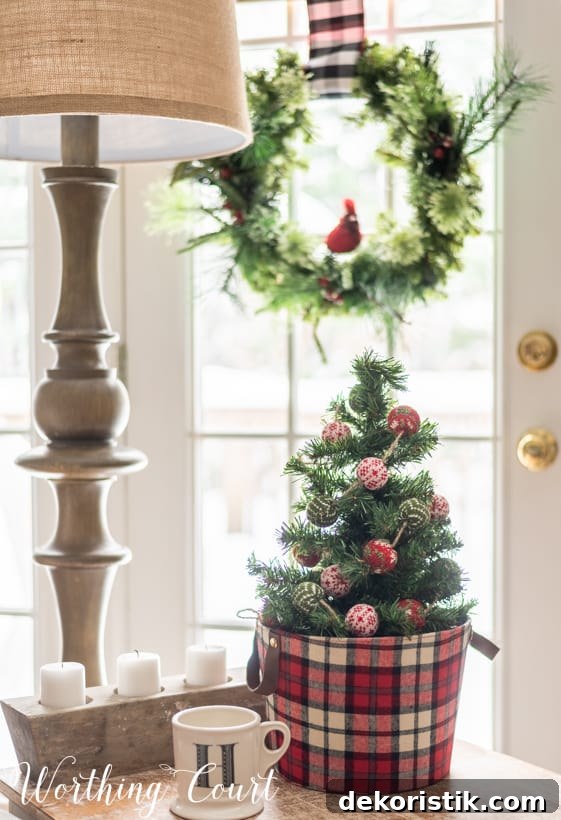 There is a small Christmas tree on the table beside the couch.