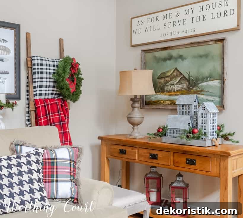 Console table decorated with galvanized houses for Christmas.