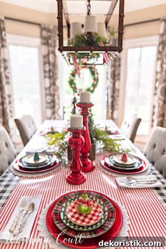 Shiny red candlesticks on the table in the middle.