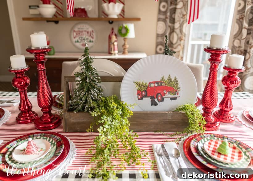 Christmas table centerpiece with a wooden toolbox filled with mini trees and plates with red trucks.
