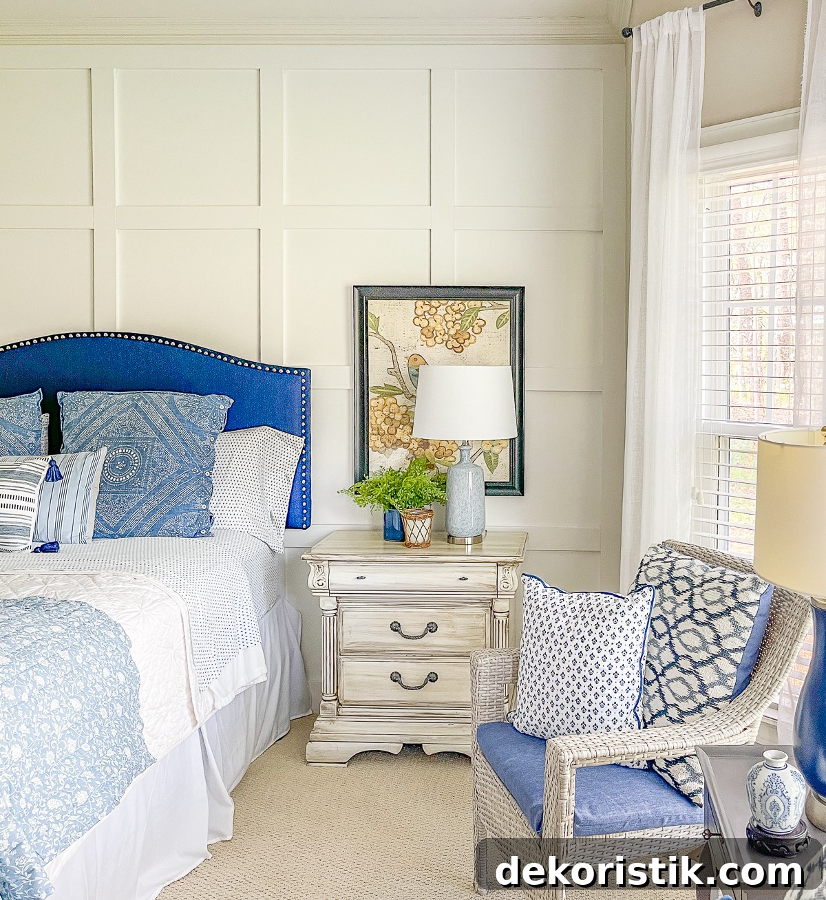 cottage style budget bedroom makeover with a navy blue upholstered headboard, board and batten feature wall, diy painted furniture and cottage style accessories