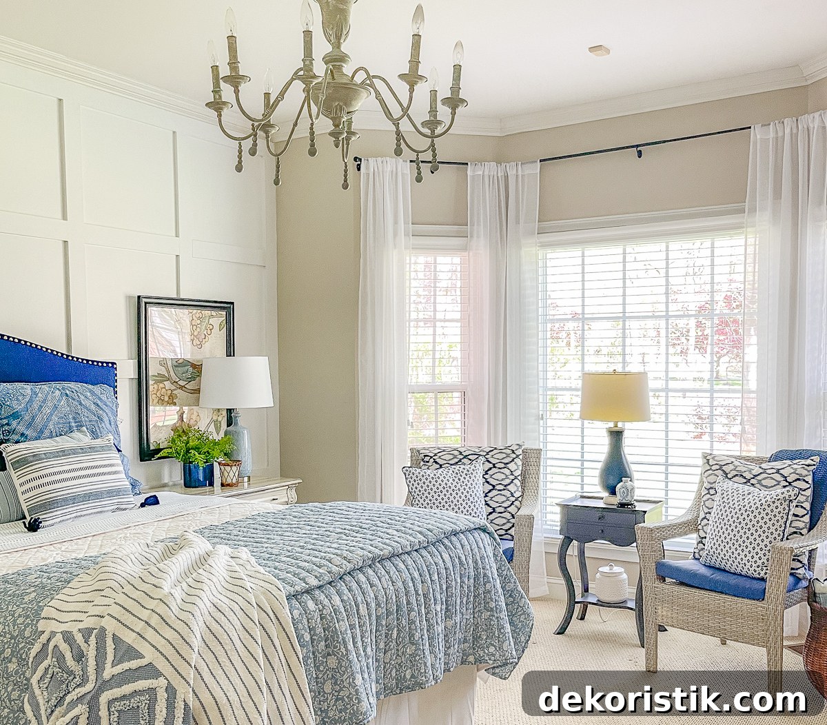 cottage style budget bedroom makeover with a navy blue upholstered headboard, board and batten feature wall, diy painted furniture and cottage style accessories