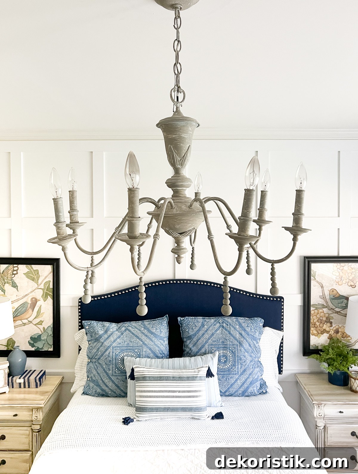 cottage style budget bedroom makeover with a navy blue upholstered headboard, board and batten feature wall, diy painted furniture and cottage style accessories