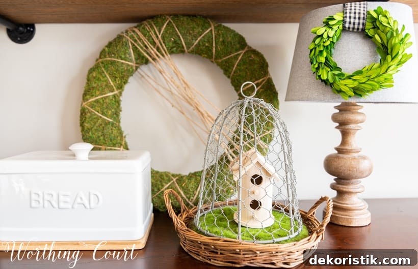 6 Spring Home Decor Items to Refresh Your Space 2 Spring vignette with greenery and natural wood elements.