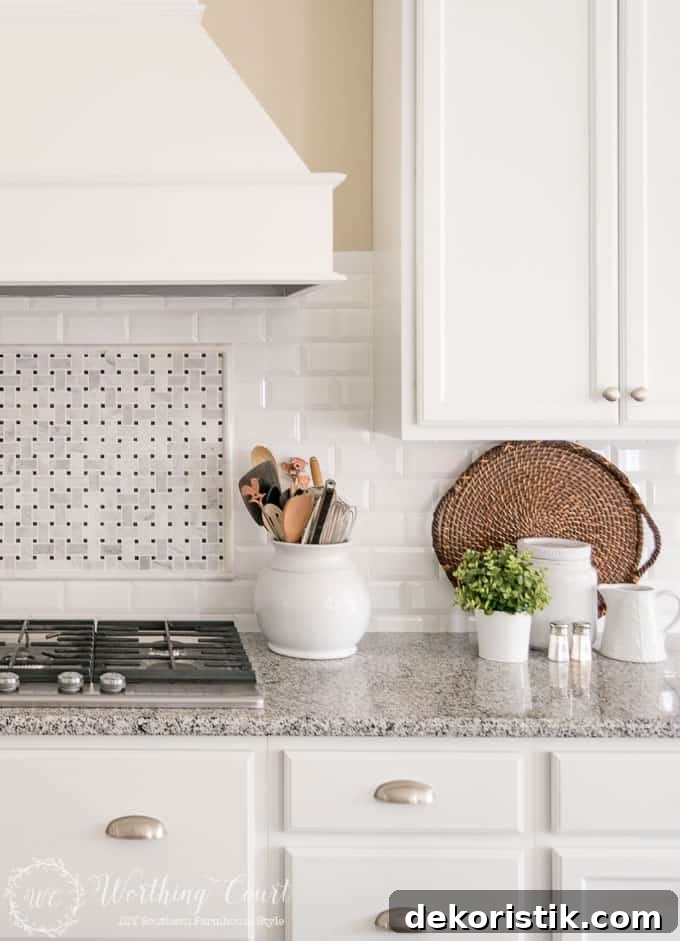 6 Spring Home Decor Items to Refresh Your Space 12 White kitchen cabinets with wicker tray leaning against the backsplash.