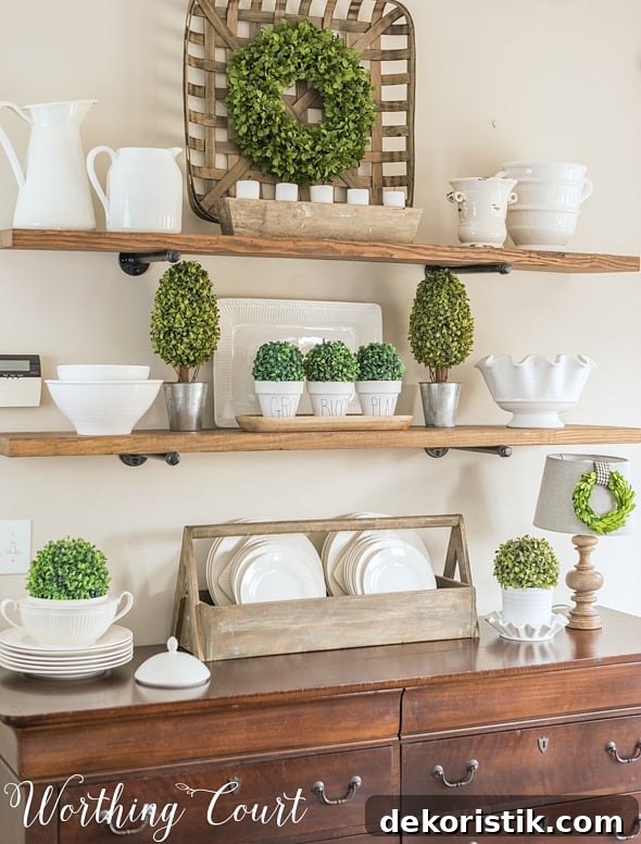 6 Spring Home Decor Items to Refresh Your Space 3 Open shelves decorated with white dishes and greenery.