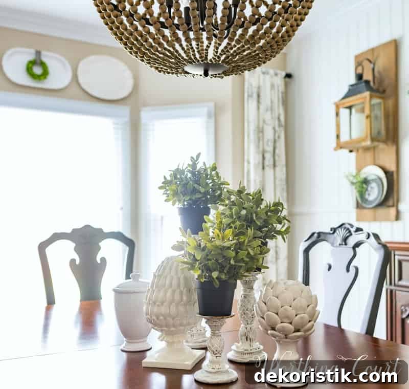 6 Spring Home Decor Items to Refresh Your Space 4 Spring centerpiece with white accessories and greenery.