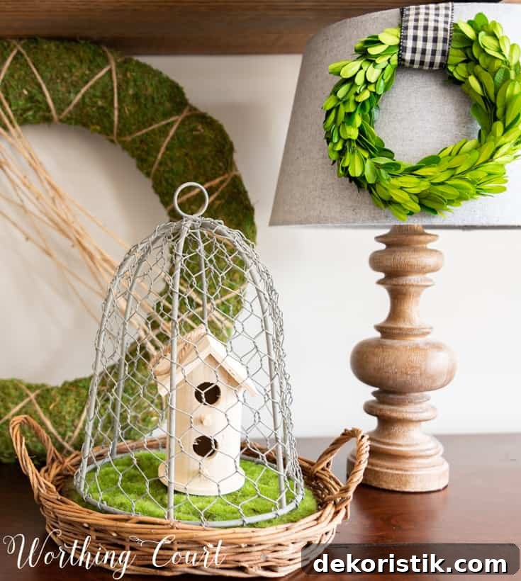 6 Spring Home Decor Items to Refresh Your Space 5 Wood birdhouse under a wire cloche.