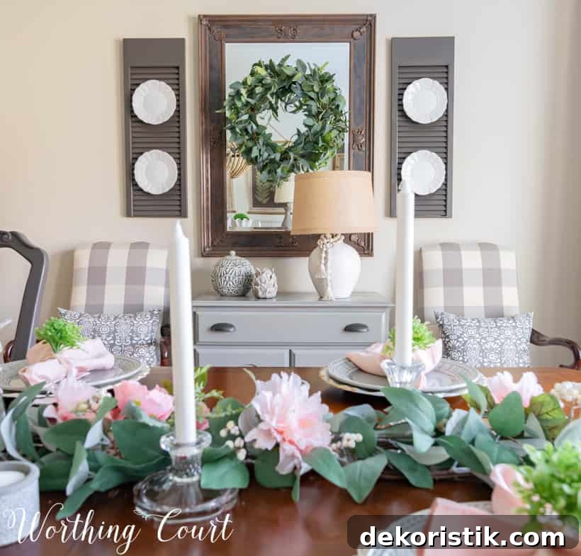 There are white candles on the dining room table.