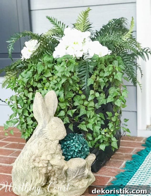 black basket planter with green ivy and a decorative rabbit