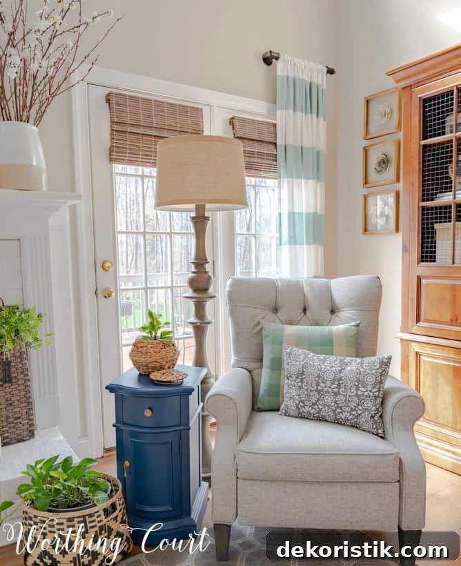There is a blue side table beside a neutral recliner.