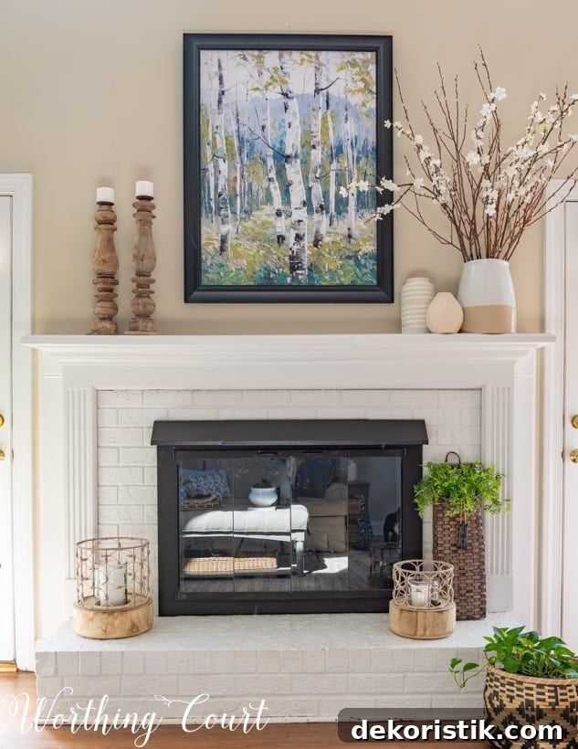 There is a nature picture hanging above the fireplace.