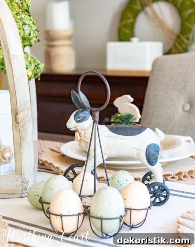 black and white Easter decorations with coloured eggs in a white egg holder.