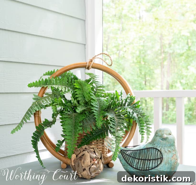 outdoor vignette on a sidetable with bird and fern