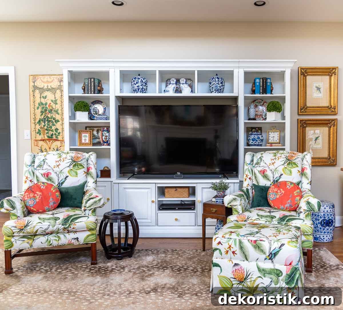 old entertainment center painted white and redecorated with updated traditional and chinoiserie accessories