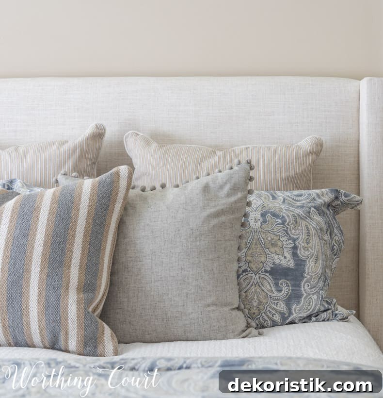 solid, stripe and paisley pillows displayed on a bed