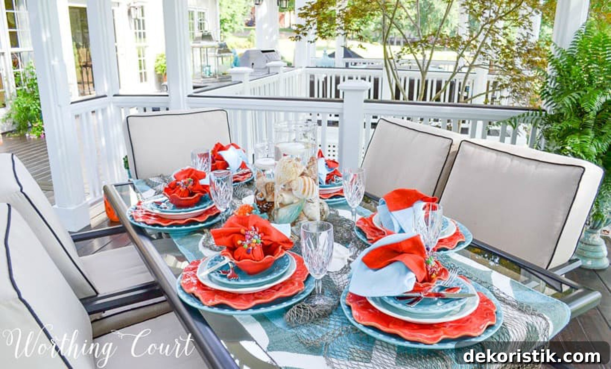 outdoor dining table set with a coastal theme using blue and coral dishware and coastal accessories