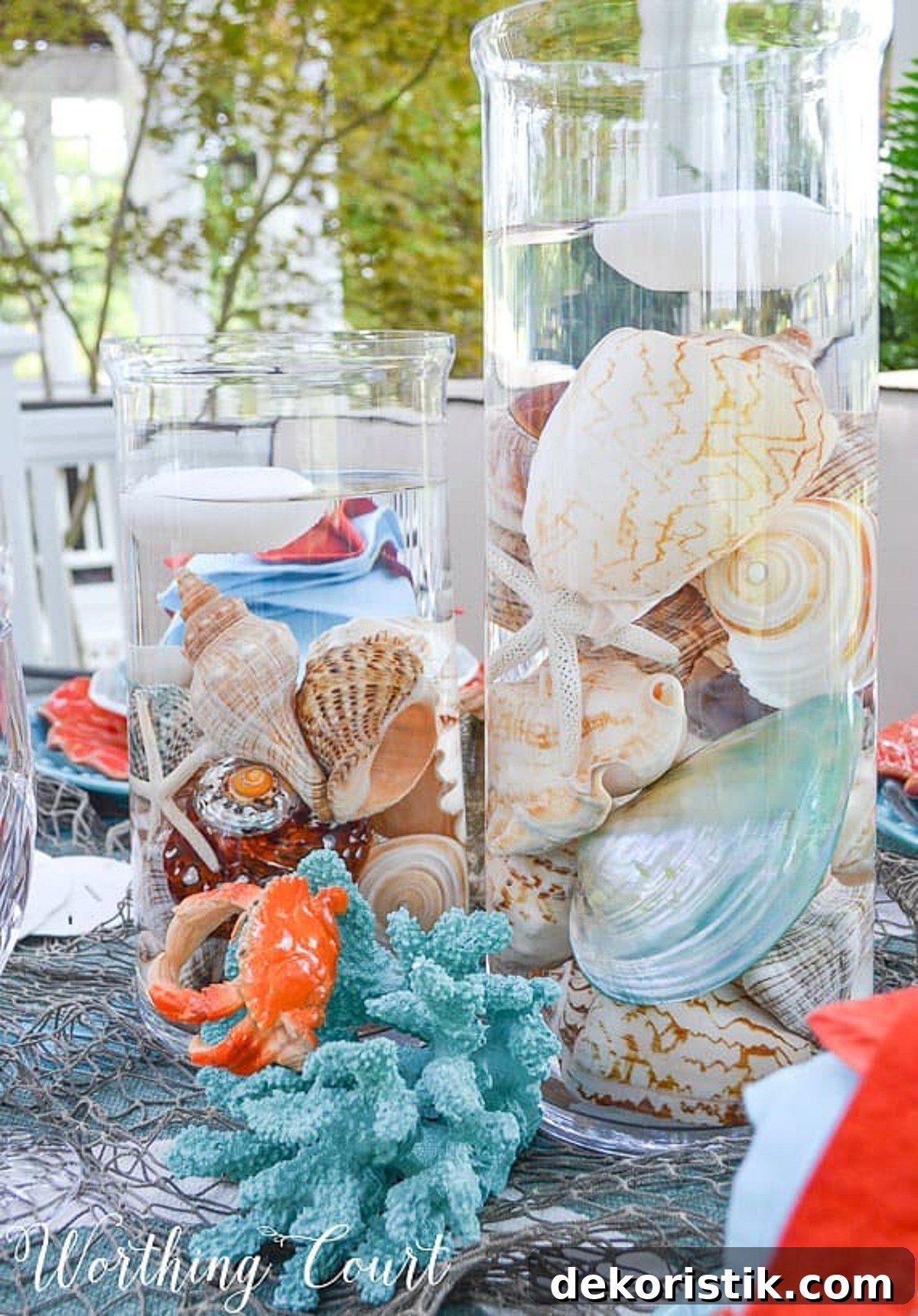 outdoor dining table set with a coastal theme using blue and coral dishware and coastal accessories