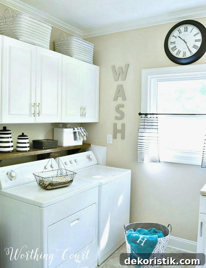 laundry room with white cabinets and beige walls
