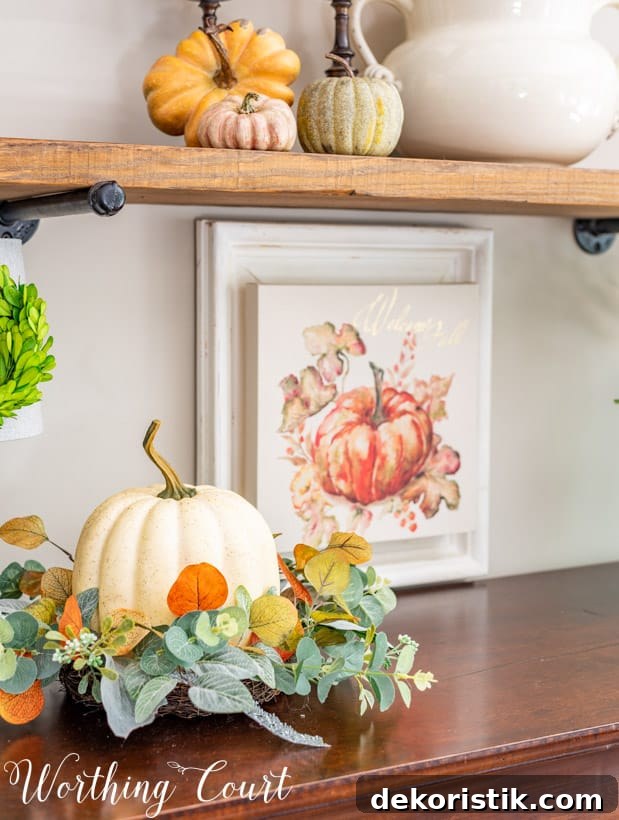 Fall Shelf Decor Ideas for Cozy Breakfast Nook and Centerpiece 6 fall vignette with a faux pumpkin nestled in a ring of greenery