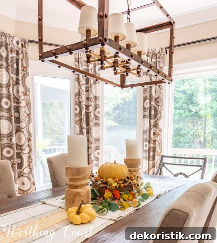 Fall Shelf Decor Ideas for Cozy Breakfast Nook and Centerpiece 7 fall centerpiece with chunky candles, a faux pumpkin and muted fall colors