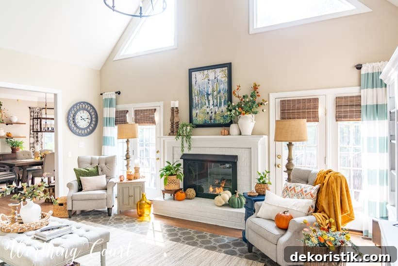 Neutral living room and white painted brick fireplace with fall decor.