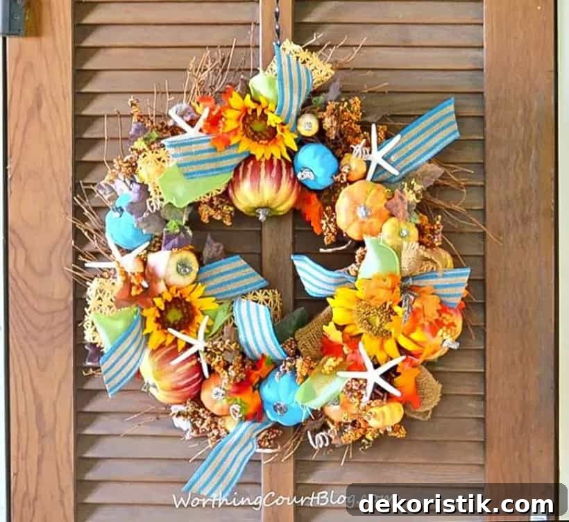 Fall wreath embellished with pumpkins, sunflowers, starfish and ribbon.