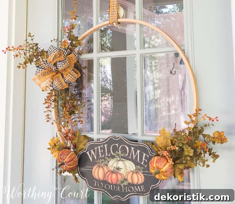 Fall wreath made using an embroidery hoop with a welcome to our home sign.