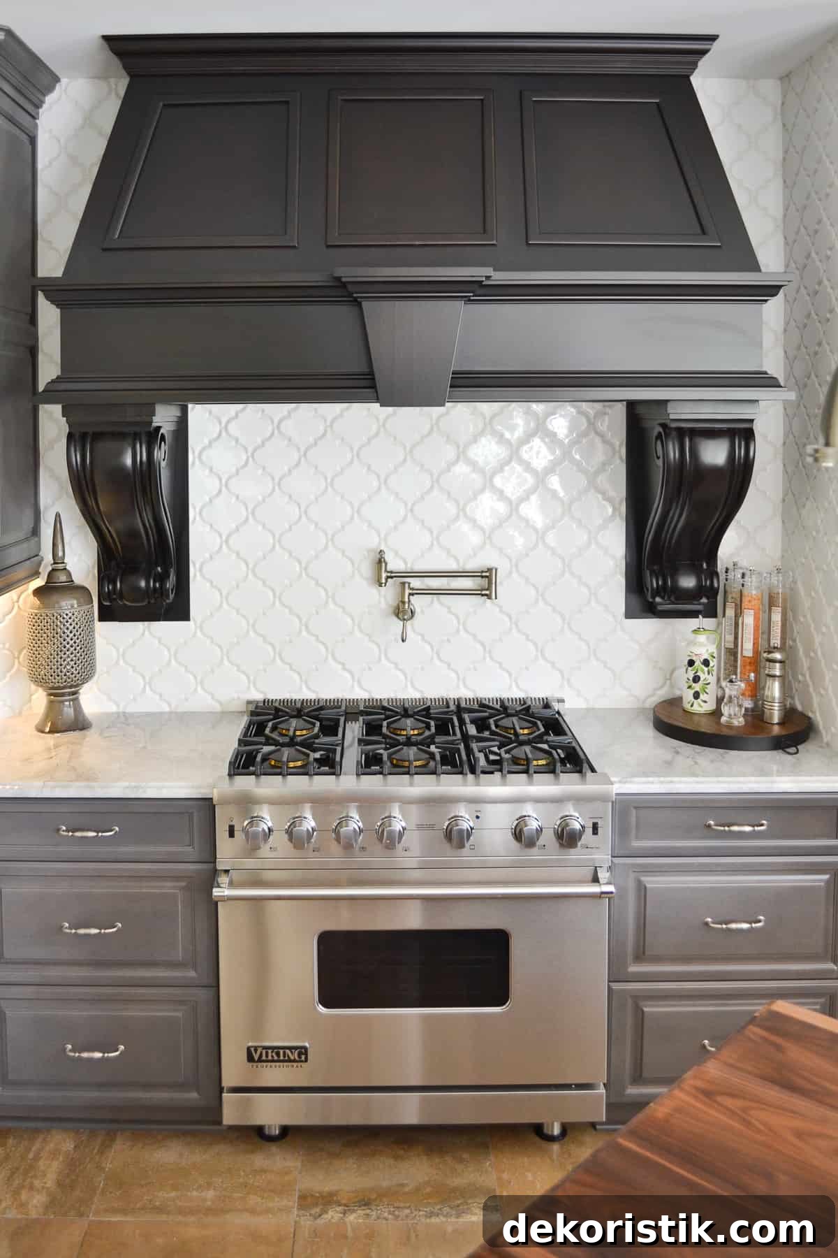 Kitchen Ideas: Small Refreshes to Full Remodels 12 huge custom black hood above a Viking range with a white quadrifoil tile backsplash