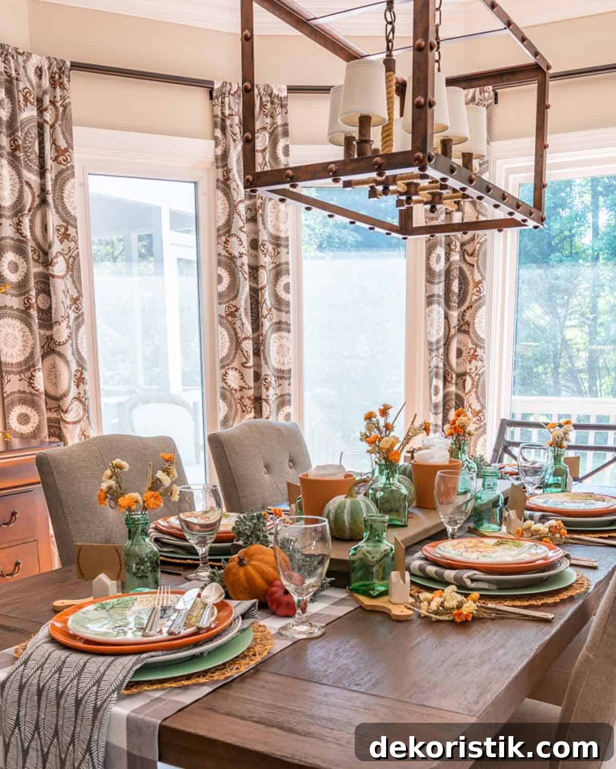 Table set for Thanksgiving with traditional fall colors and aqua as an accent color