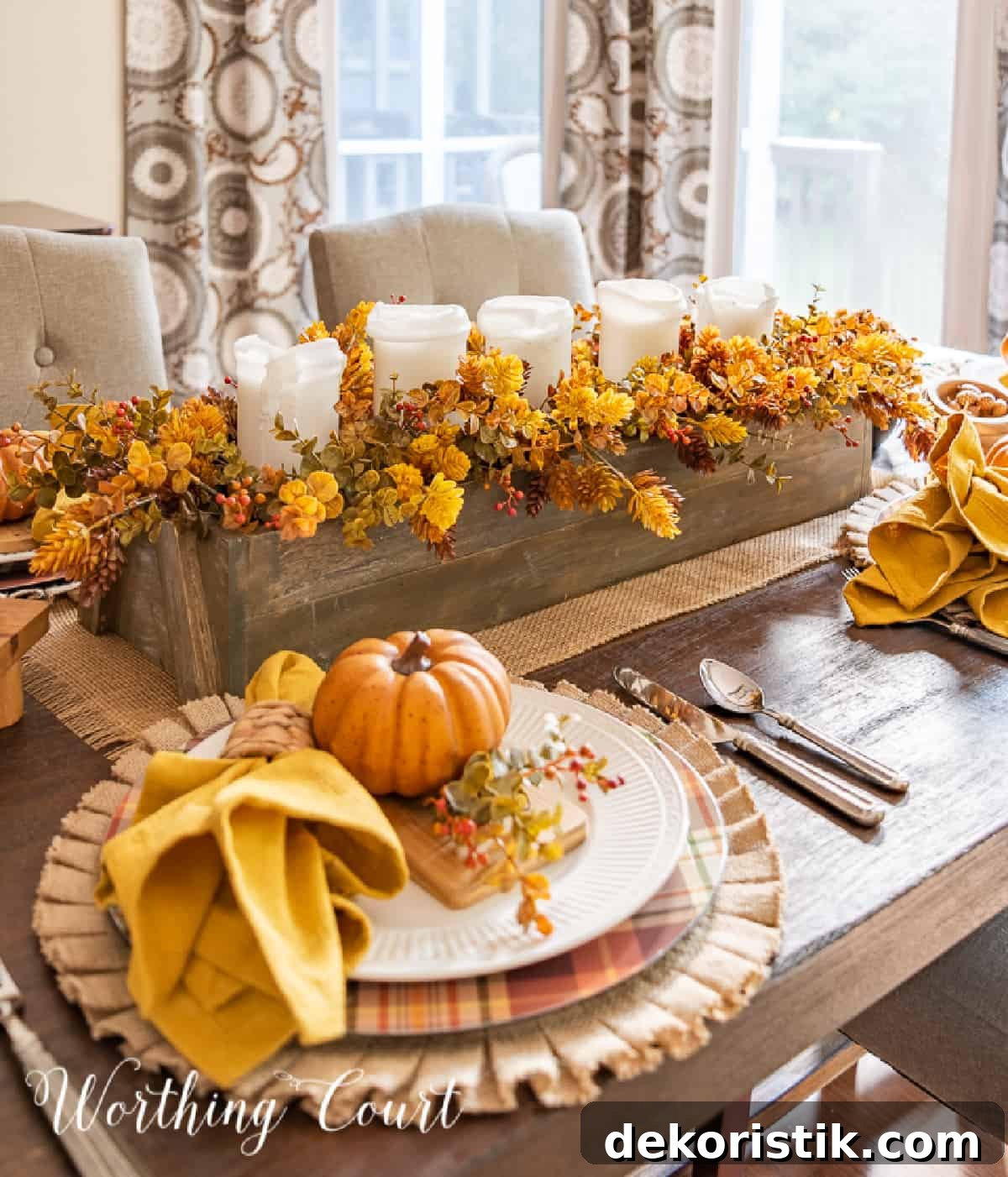 Thanksgiving place setting with a burlap placemat, plaid charger, white dinner plate and fall accessories.