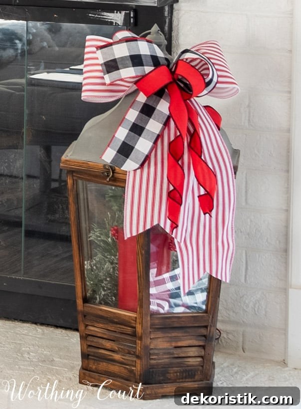 There are red ribbons tied to the top of the lantern.