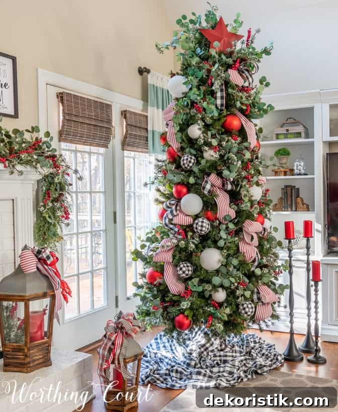 There is a large Christmas tree decorated by the window in the corner of the house.