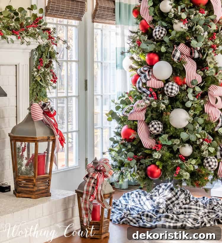 A lantern with a red candle in it is beside the Christmas tree.