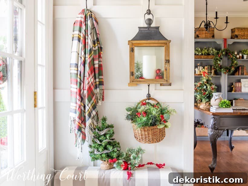 There is a lantern with a candle hanging from the wall in the entryway.