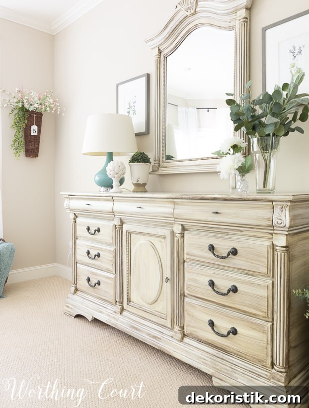 Traditional bedroom dresser painted with white paint and dry brushed with gray paint.