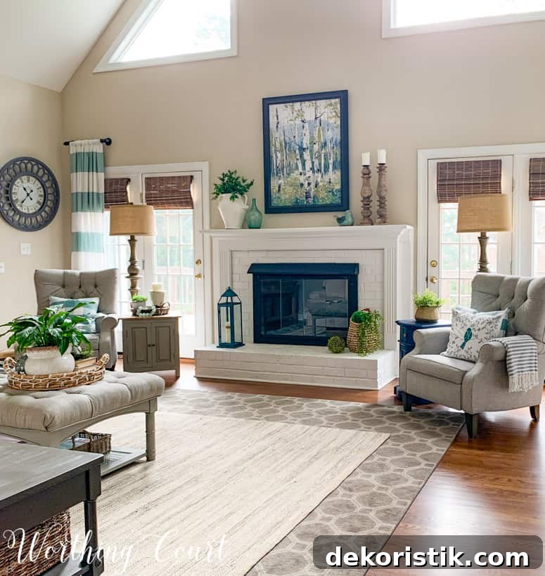 fireplace decorated for spring flanked by two gray chairs