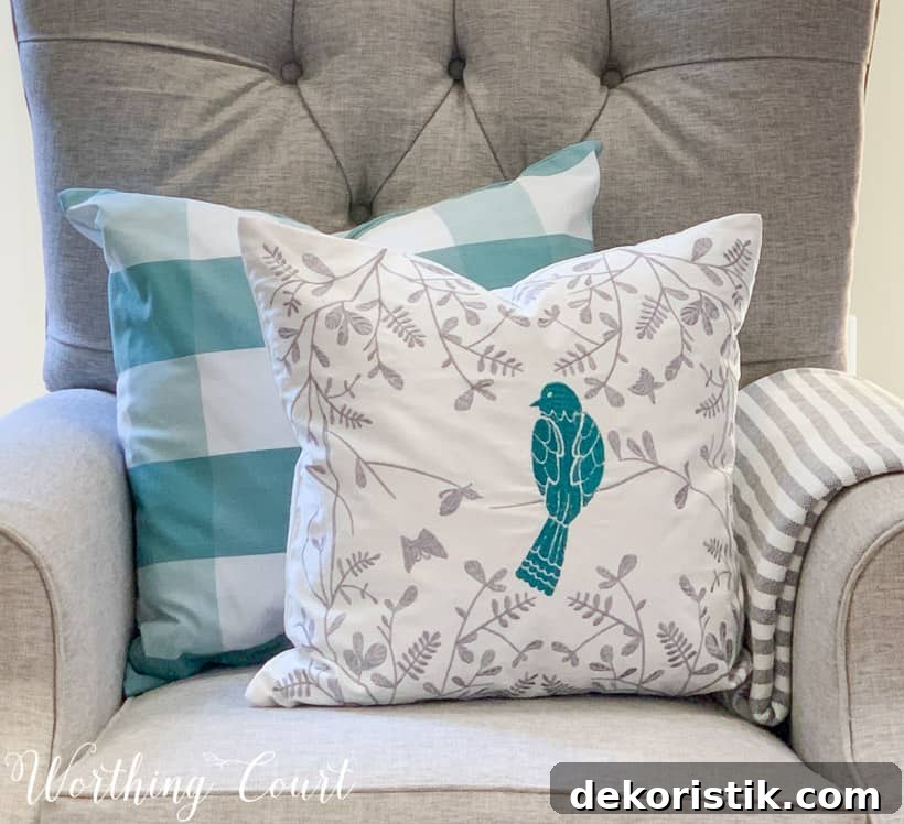 two blue and white spring pillows on a gray chair