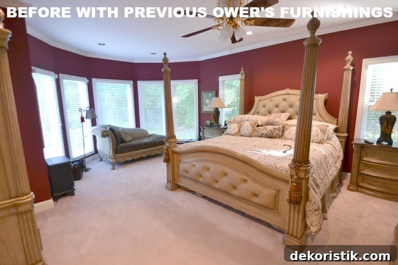 Master bedroom with red walls and a four poster bed.