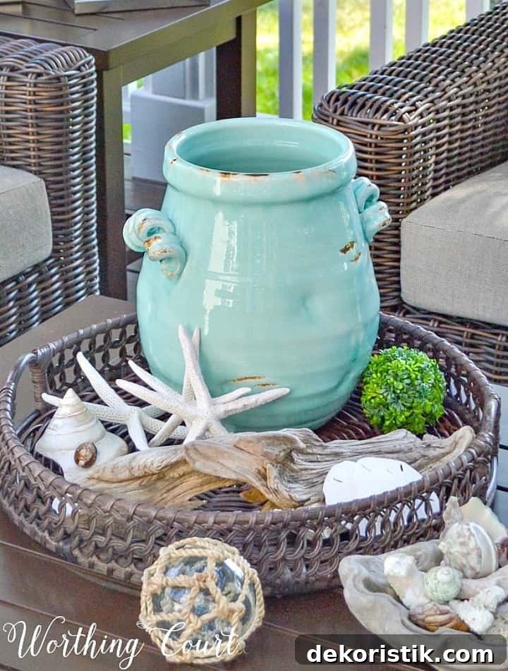 Coastal vignette in a round basket with a blue ceramic vase and starfish.