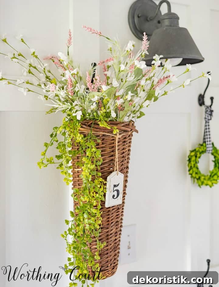 Wicker basket filled with faux florals hanging on the wall.