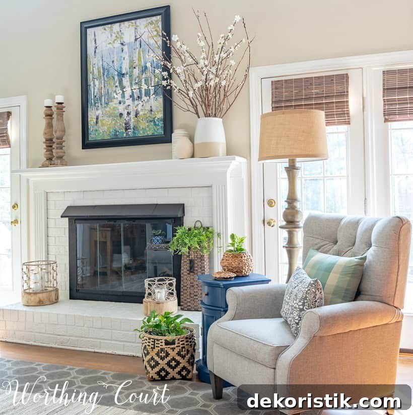 Gray recliner beside white painted brick fireplace.