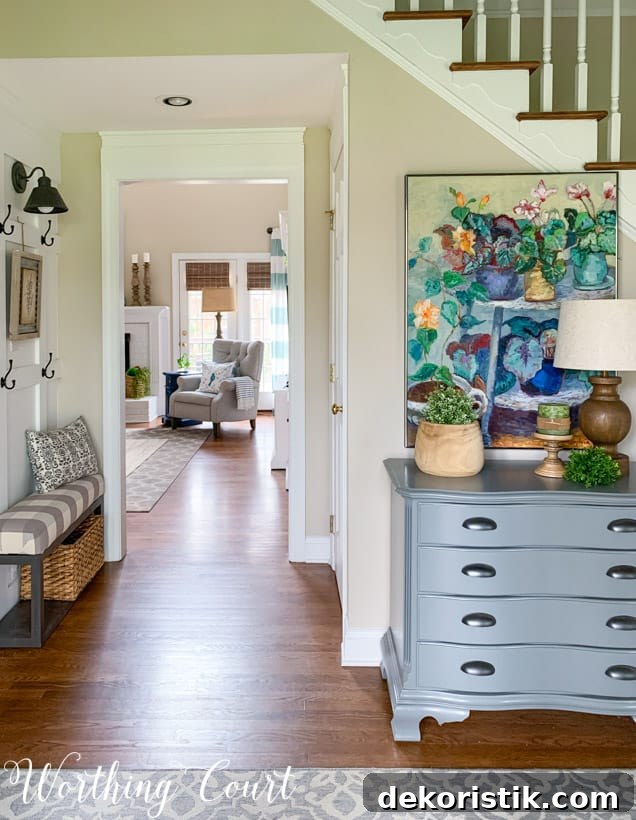 Entryway with colorful painting looking through to family room.