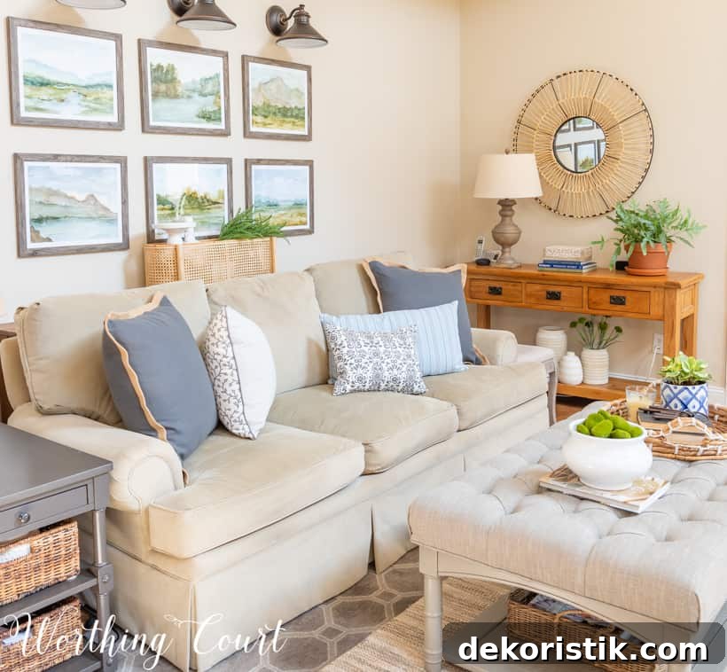 Sofa with gallery wall above and blue throw pillows on the couch.