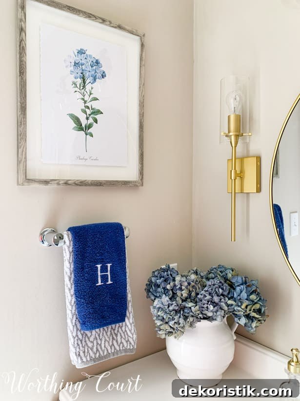Master bathroom vanity accessories with a white vase filled with hydrangeas.