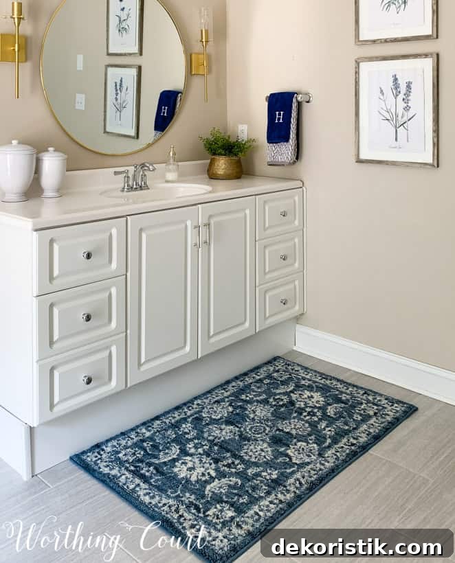 Blue bath mat in front of white bathroom vanity