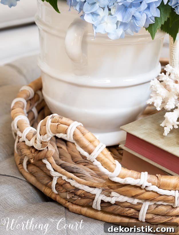 Wicker tray on a coffee table containing a summer vignette.