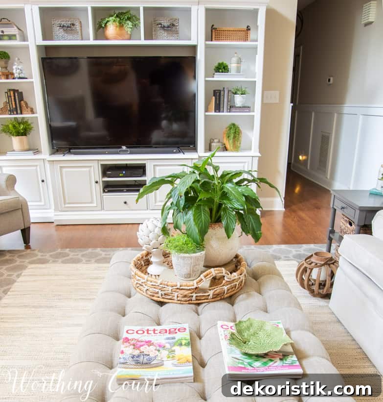 upholstered coffee table and white entertainment center with accessories