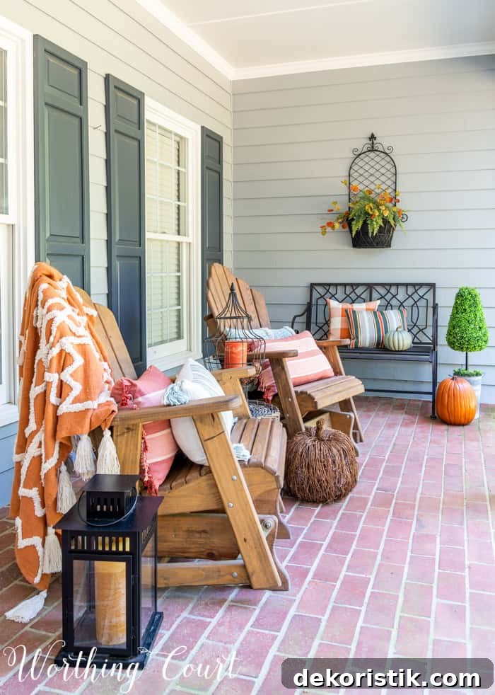front porch with Adirondack gliders decorated for fall
